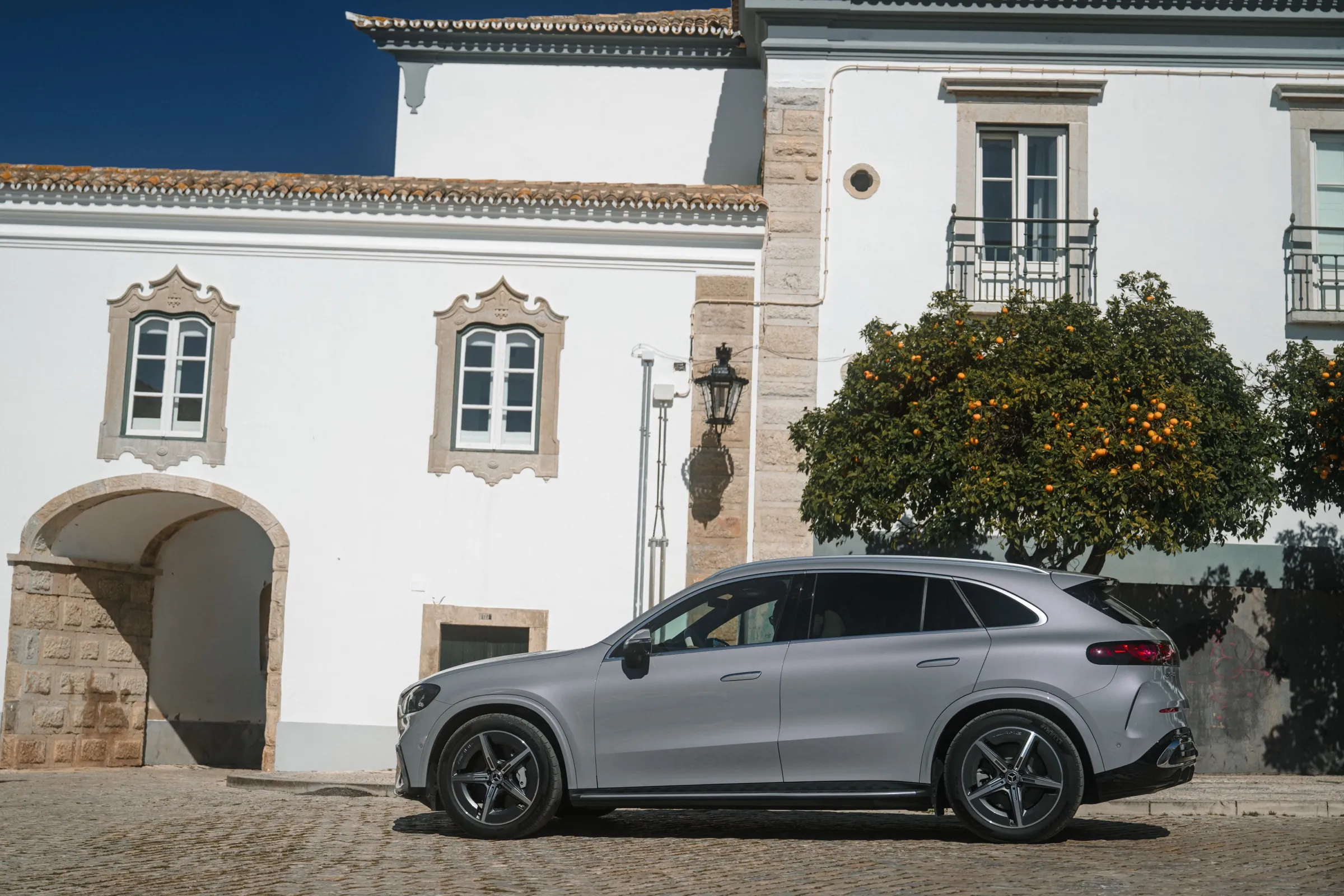 Electric Mercedes GLC in a village street, side view