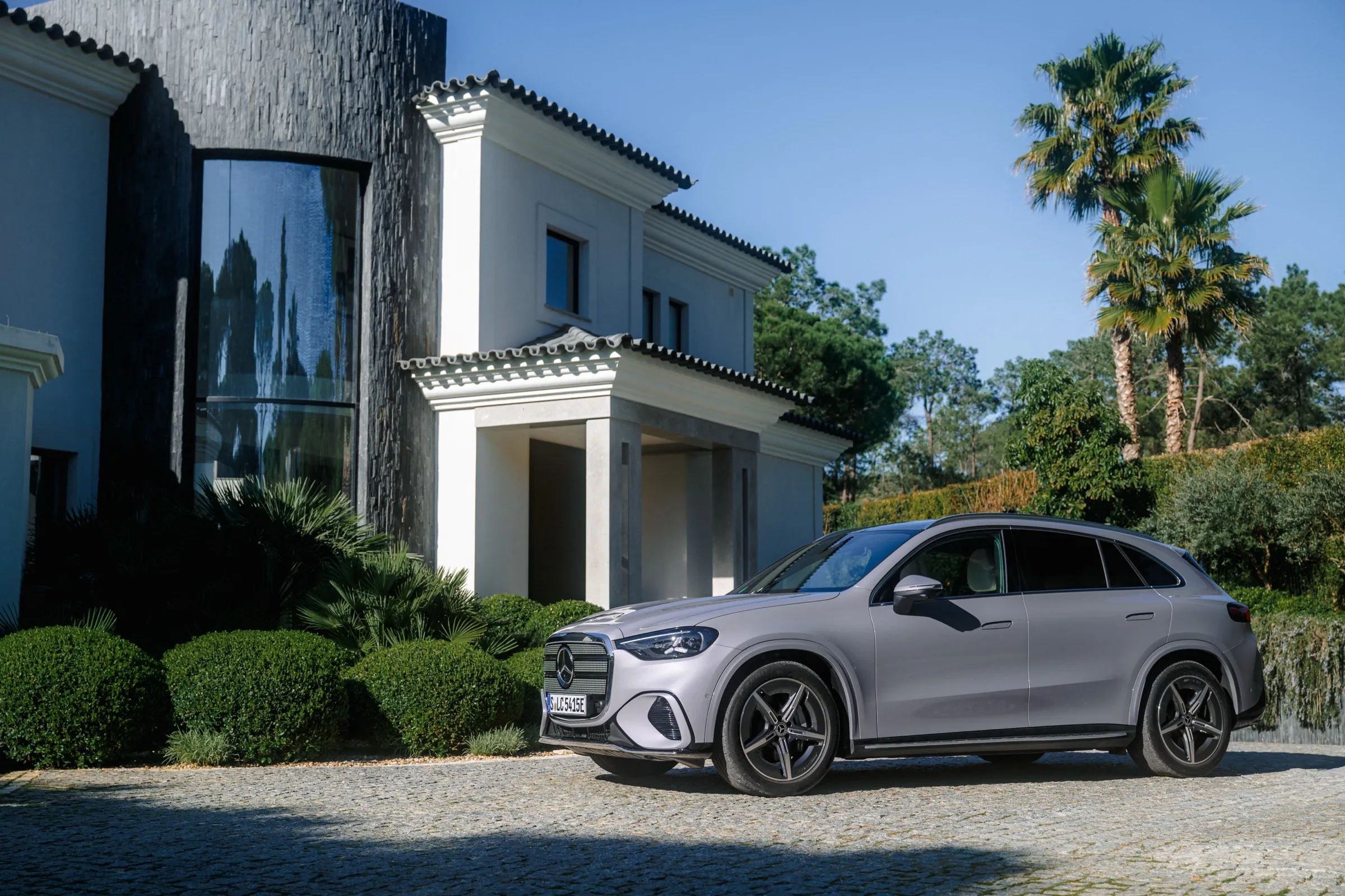 Electric Mercedes GLC parked outside a white villa