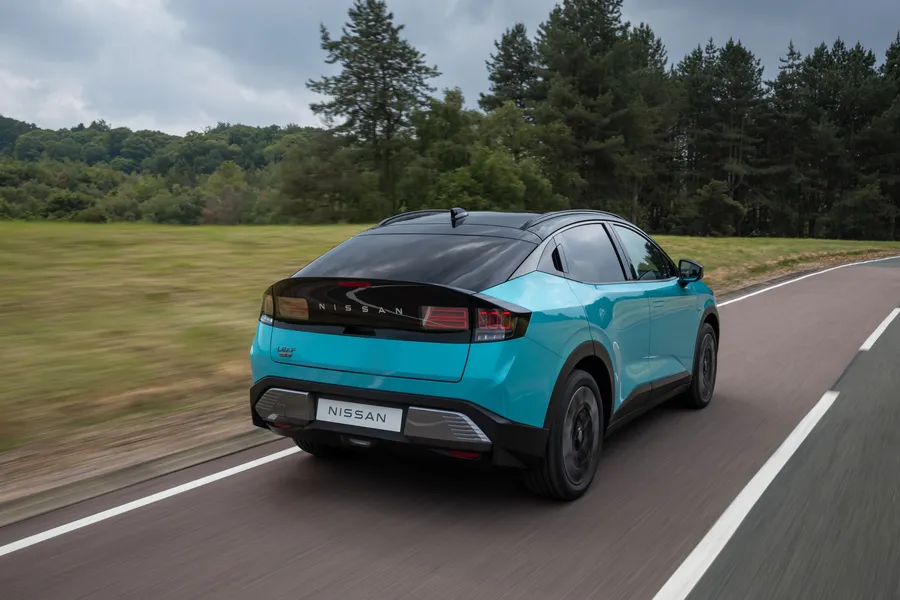 Rear three-quarter view of the Nissan Leaf driving