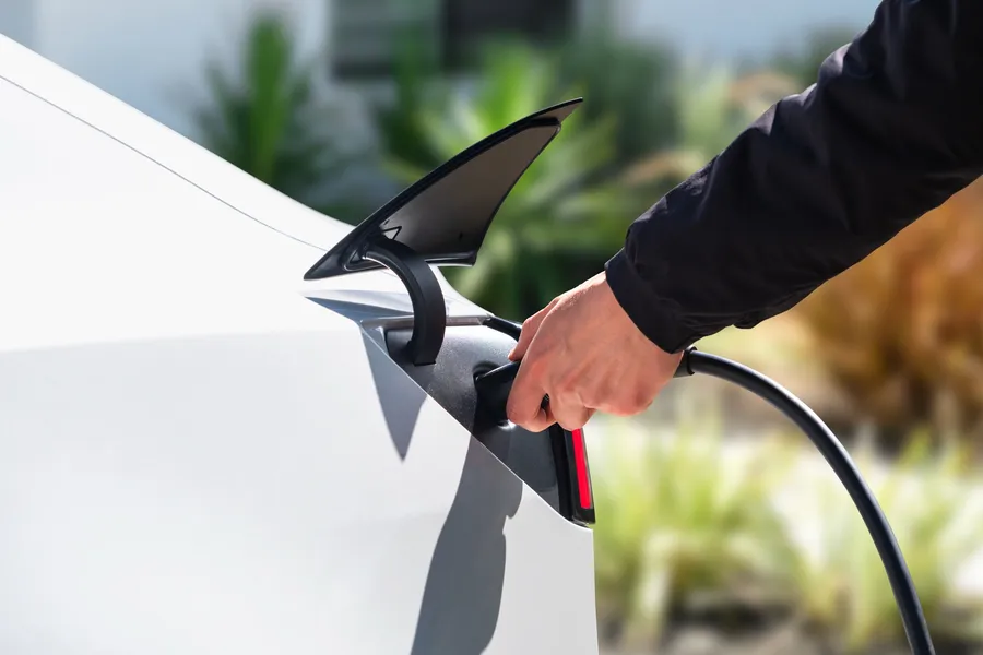 Tesla Model 3 being plugged in to charge