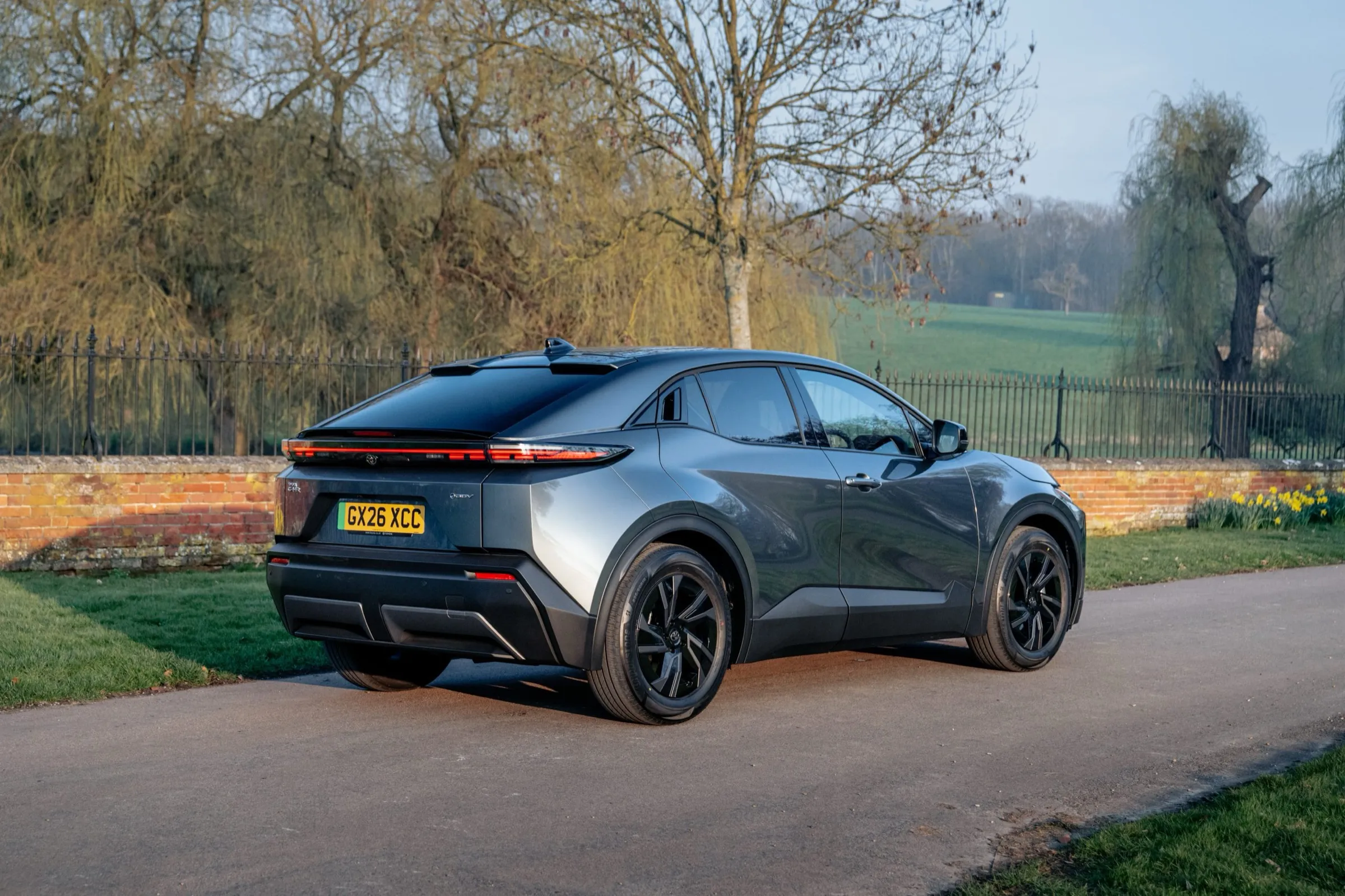 Toyota C-HR+ rear three-quarter view with full-width light bar